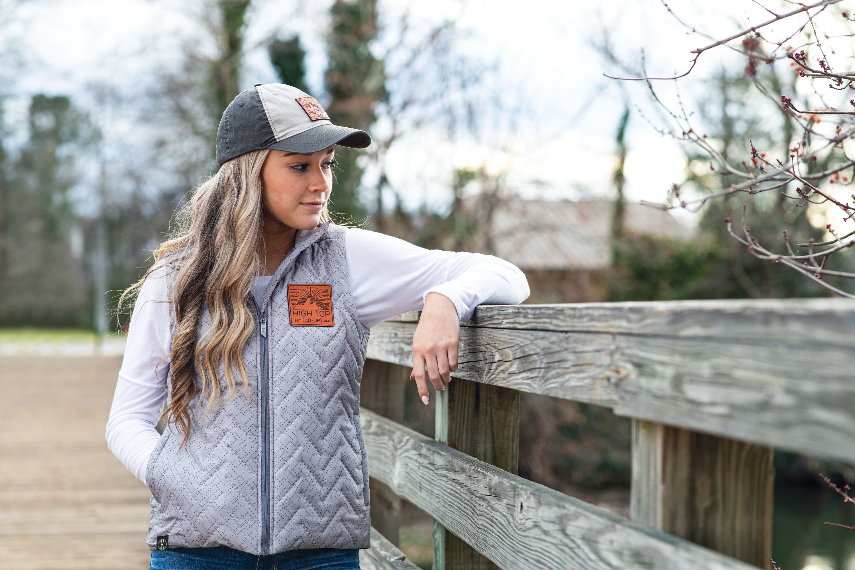Woman Modeling High Top Vest And Ball Cap