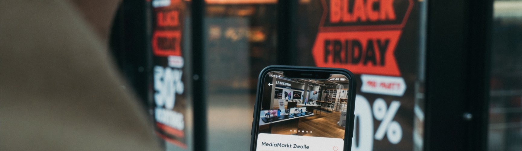 Black Friday shopper outside of store looking up business on Google