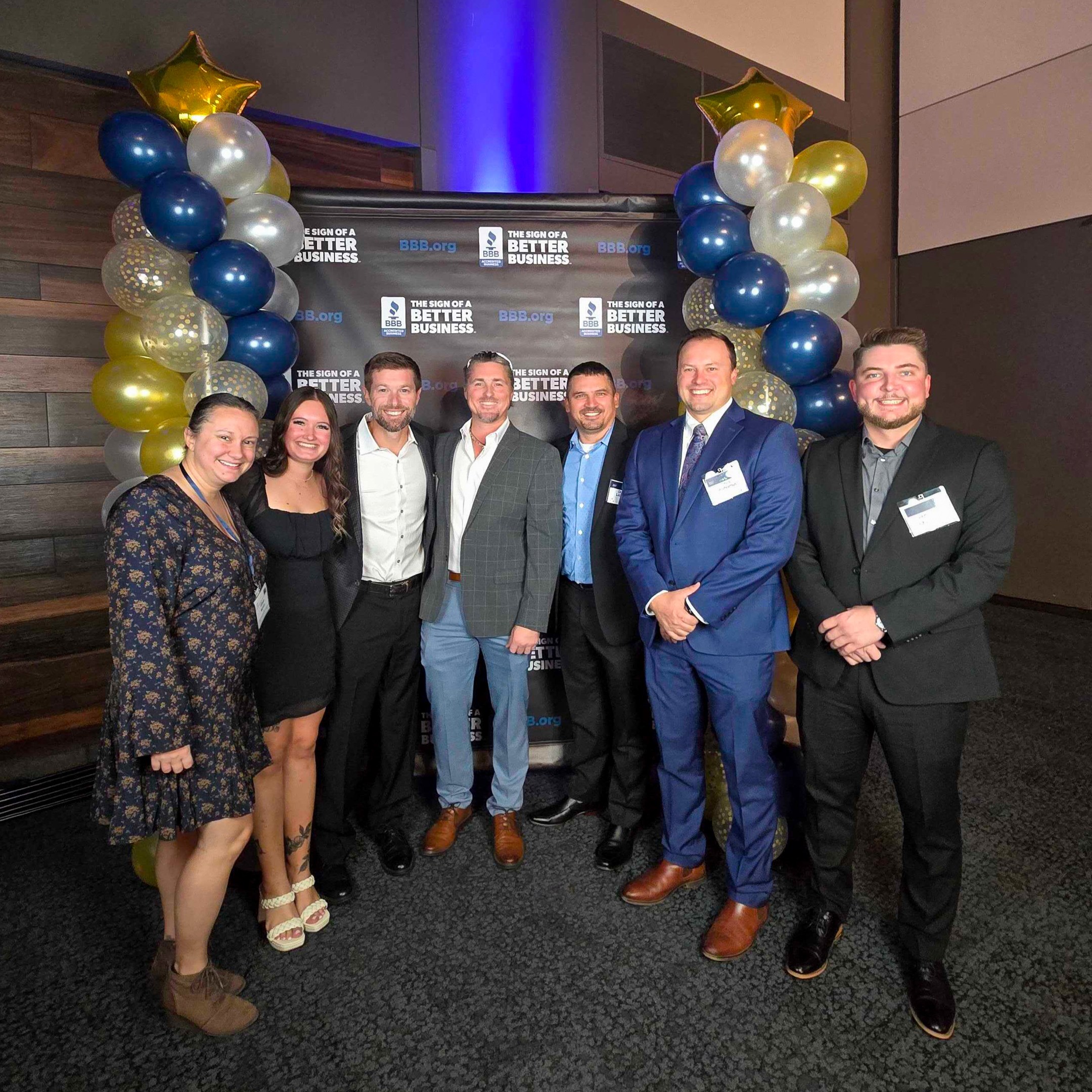 Group photo of JH employees at event