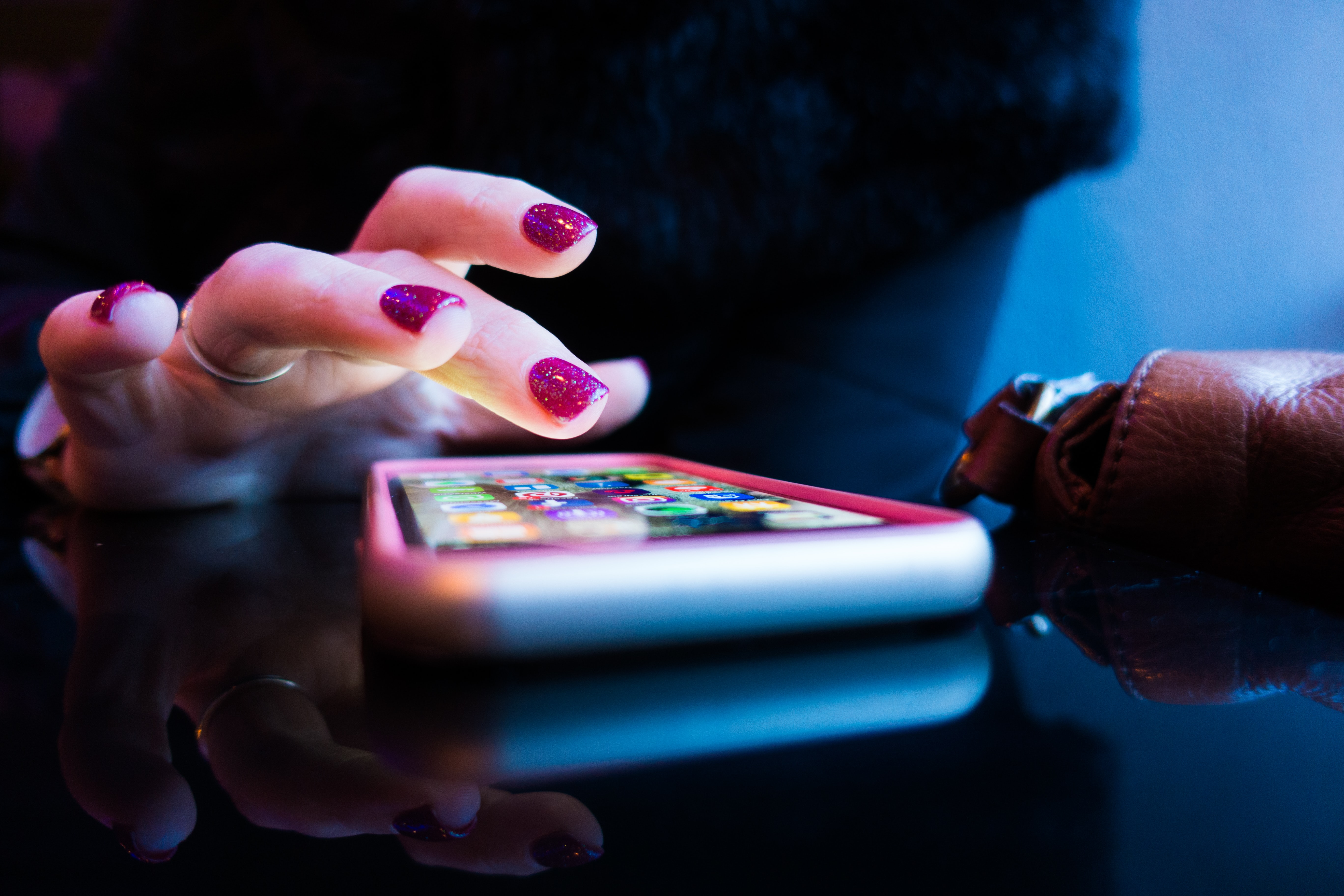 Woman tapping an app on phone