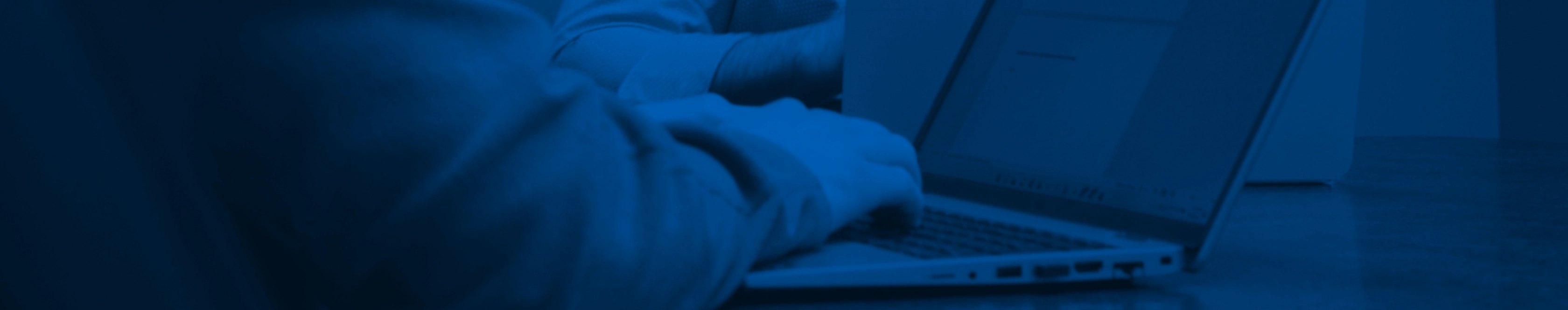 background image of person typing on computer in orange hue